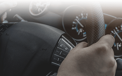 Close up of hands on steering wheel