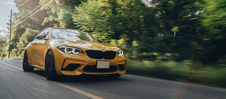 Yellow BMW on country road