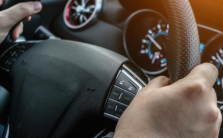 Hands on a steering wheel